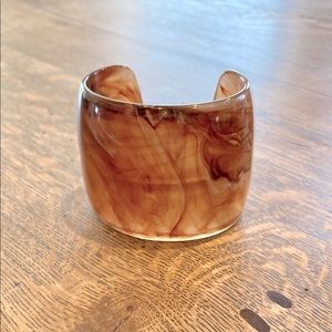 A wide cuff bracelet.
